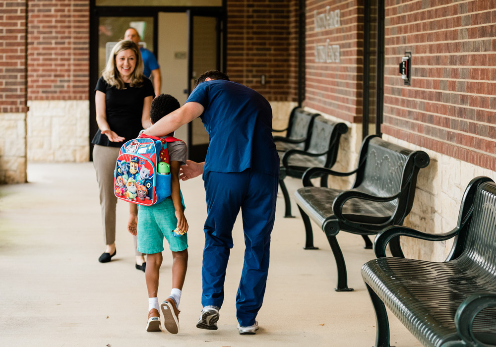 Student walking into Kristin Farmer Autism Center